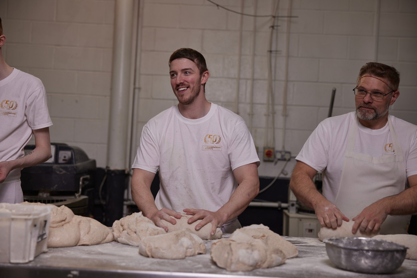 Bakers shaping dough at The Breadwinner Bakery